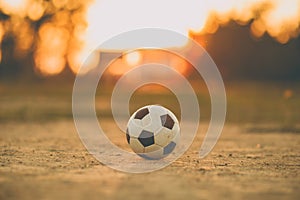 A ball for street soccer football under the sunset ray light. Film picture style.