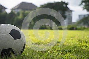 A ball for street soccer football under the sunset ray light in grass field area with abstract lights blurred bokeh copy space