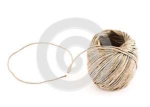 Ball of strong brown string over white background