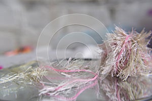 A ball of thread unwound on a gray background