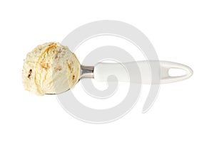 Ball of vanilla ice cream with nuts and caramel in scoop