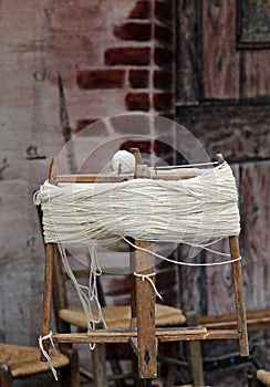 ball of wool just made with an old wooden spinning wheel by the