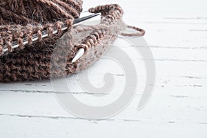 Ball of wool yarn and knitting needles on light background