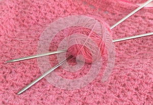 Ball of yarn and knitting needles