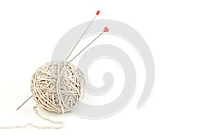 Ball of yarn with knitting needles isolated on white background