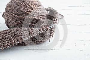 Ball of yarn and knitting needles on light background