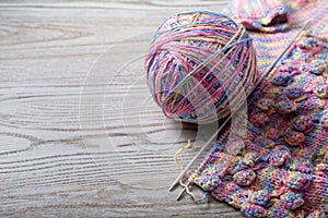 Ball of yarn and knitting on a table