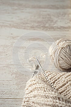Ball of yarn and knitting on a table