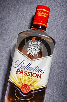 Ballantines passion spirit drink on stone slate background.