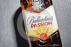 Ballantines passion spirit drink on stone slate background.