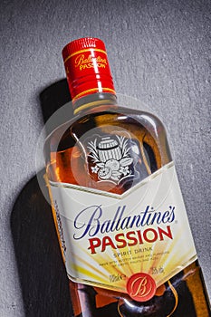 Ballantines passion spirit drink on stone slate background.