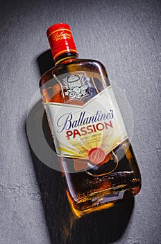 Ballantines passion spirit drink on stone slate background.