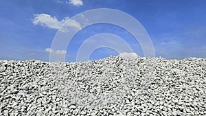 Ballast stone mound against blue sky
