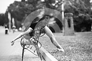 Ballerina bends back through the bench