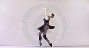 Ballerina in black swan dress. Young ballet dancer practicing before performance in black tutu, classical dance studio, copy space