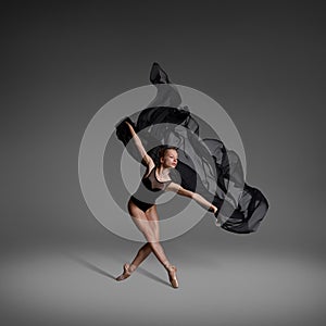 Ballerina dancing with black cloth