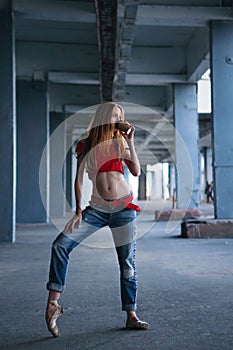 Ballerina dancing with cup of coffee. Street performance.