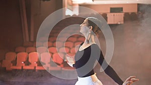 Ballerina dancing on the stage of the theatre. Steadicam. Slow motion. HD.