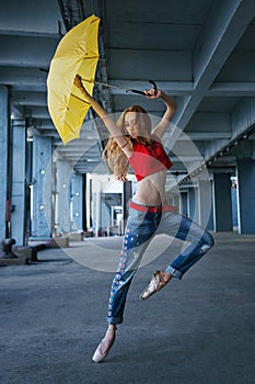 Ballerina dancing with umbrella. Street performance.