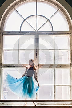 Ballerina dancing at window sill background