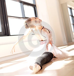 Ballerina Doing Splits in Sunny Studio photo