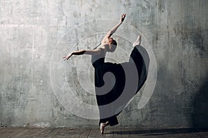 Ballerina female. Young beautiful woman ballet dancer, dressed in professional outfit, pointe shoes and white tutu.