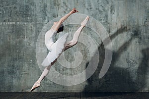 Ballerina female. Young beautiful woman ballet dancer, dressed in professional outfit, pointe shoes and white tutu.