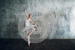 Ballerina female. Young beautiful woman ballet dancer, dressed in professional outfit, pointe shoes and white tutu.