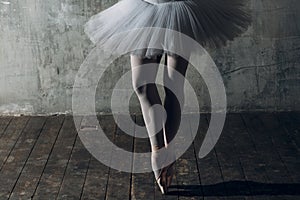Ballerina female. Young beautiful woman ballet dancer, dressed in professional outfit, pointe shoes and white tutu