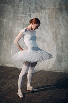 Ballerina female. Young beautiful woman ballet dancer, dressed in professional outfit, pointe shoes and white tutu.