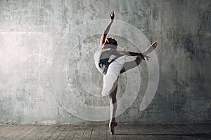 Ballerina female. Young beautiful woman ballet dancer, dressed in professional outfit, pointe shoes and white tutu.