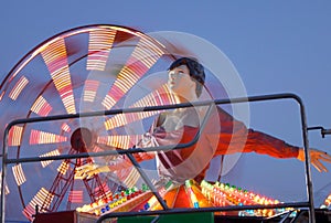 Ballerina and ferris wheel at amusement park