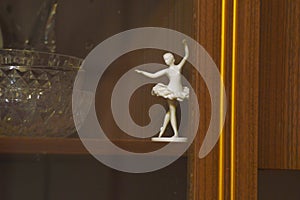Ballerina figurine on shelf in a sideboard