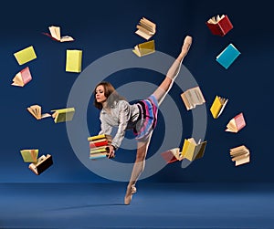 Ballerina in form of schoolgirl with pile books