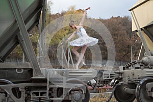 Ballerina between freight wagons