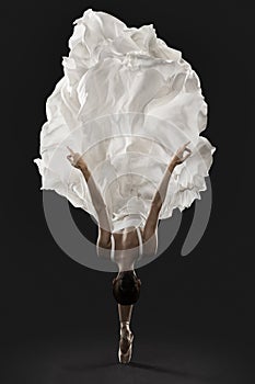 Ballerina Graceful Jump in White Silk Dress, Ballet Dancer Pointe Shoes in Fluttering Cloth photo