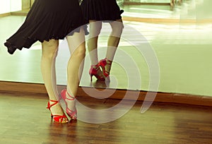 Ballerina legs latin dances with black skirt and red shoes