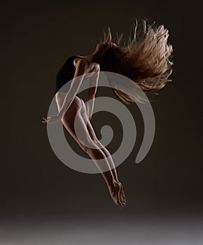 Ballerina with long hair jumping