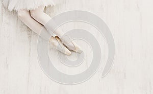 Ballerina in pointe ballet shoes, graceful legs with copy space