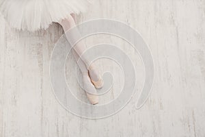 Ballerina in pointe ballet shoes, graceful legs with copy space