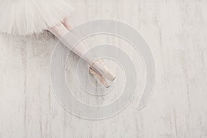 Ballerina in pointe ballet shoes, graceful legs with copy space