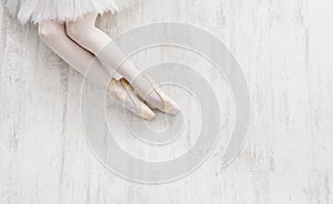 Ballerina in pointe shoes, graceful legs, ballet background