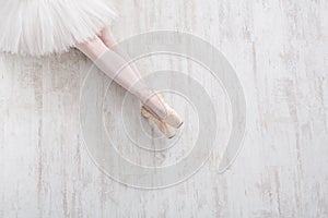 Ballerina in pointe shoes, graceful legs, ballet background