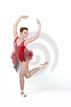 the ballerina in pointes and a dress dances on a white background