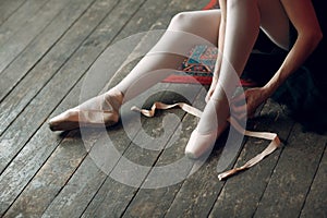 Ballerina female. Young beautiful woman ballet dancer, dressed in professional outfit, pointe shoes and white tutu.