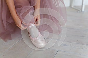 Ballerina puts pointe shoes