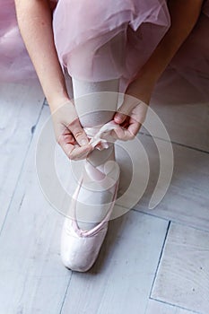 Ballerina puts pointe shoes