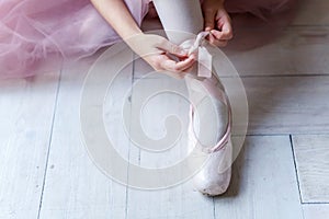 Ballerina puts pointe shoes