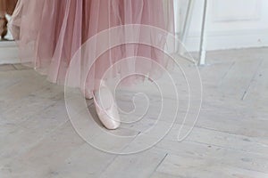 Ballerina puts pointe shoes