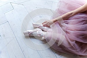 Ballerina puts pointe shoes